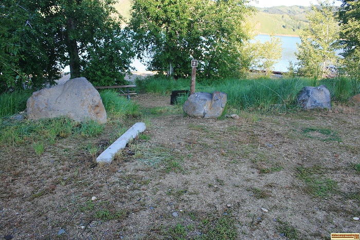 Curlew Creek Boat Ramp campsite 2, you park in the foreground and use the picnic table and fire ring. The lake is just beyond the trees.