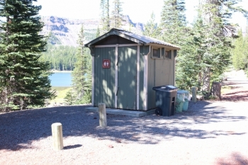 An outhouse with garbvage cans in Oregons Driftwood Campground