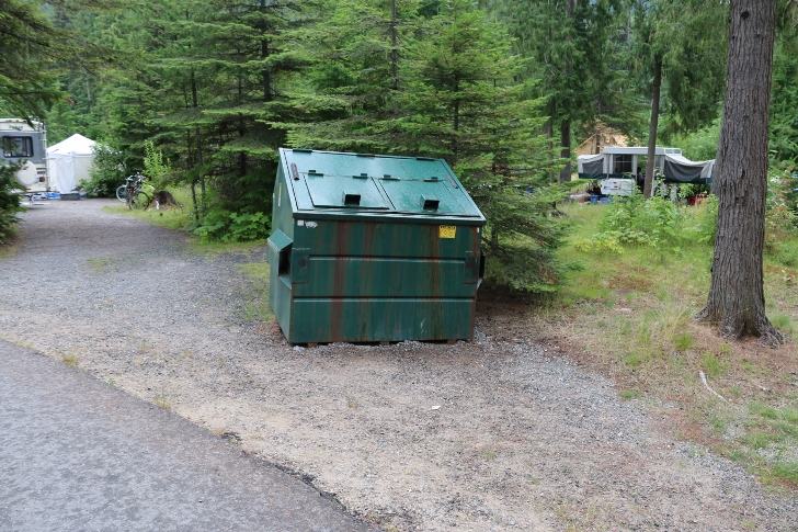 Garbage dumpsters are scattered throughout the campground.
