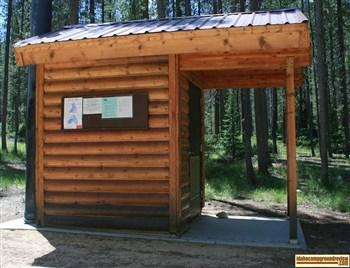 Cute log outhouse in Lola Creek Campground.