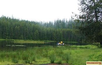 Fishermen fishing from a dock at Moose Creek Reservoir in the rain.