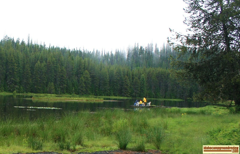 Fishermen fishing from a dock at Moose Creek Reservoir in the rain.