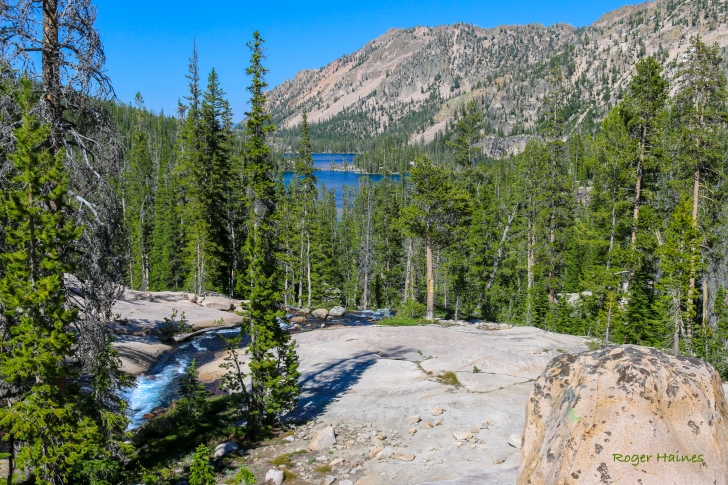 A picture of the stream running down the rock from Mushroom Lake with Imogene Lake in the distance.